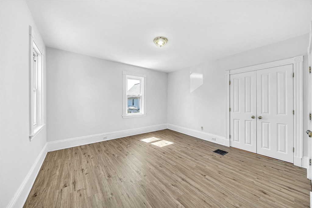 13 Weir Street Newton, MA 02466 - Photo 24 of 41 a view of an empty room with wooden floor and a window