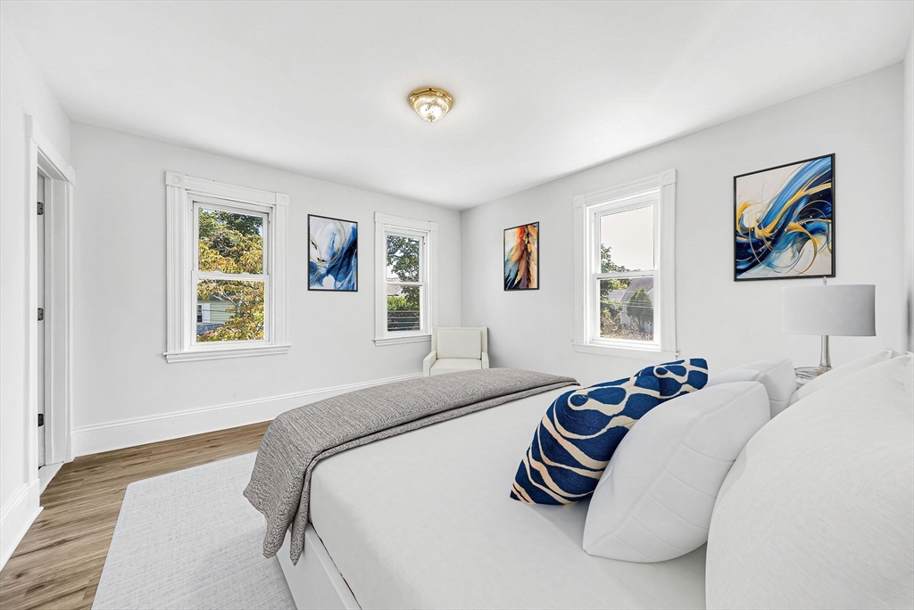 13 Weir Street Newton, MA 02466 - Photo 26 of 41 a bedroom with a bed and a painting on the wall