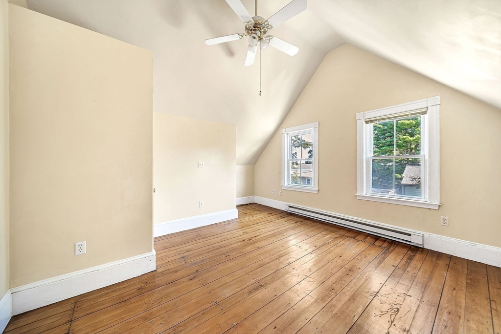 13 Weir Street Newton, MA 02466 - Photo 30 of 41 an empty room with wooden floor chandelier fan and windows
