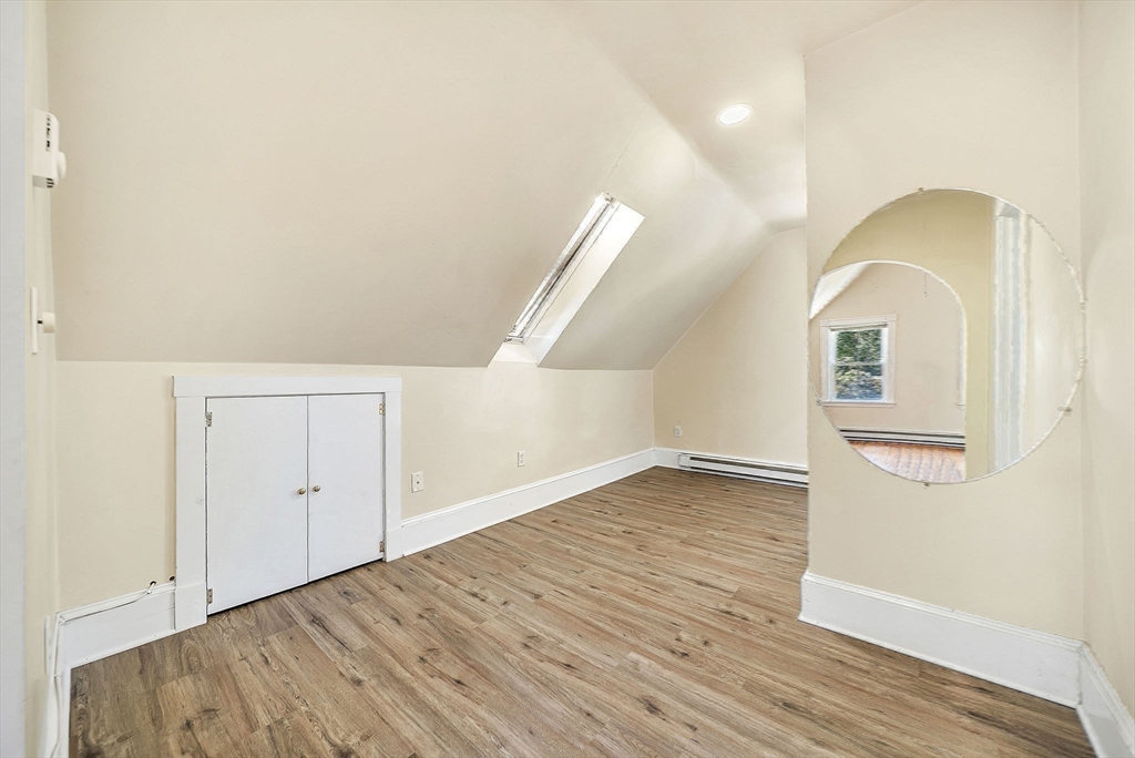 13 Weir Street Newton, MA 02466 - Photo 33 of 41 an empty room with wooden floor and windows