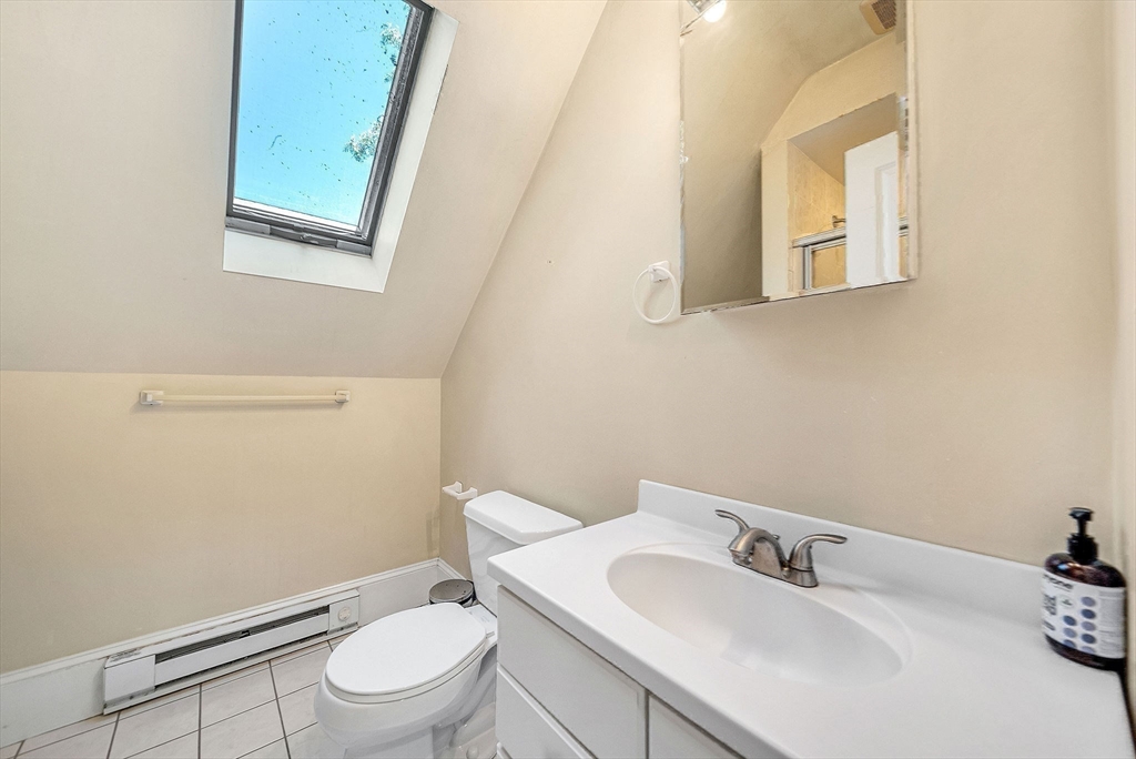 13 Weir Street Newton, MA 02466 - Photo 37 of 41 a white toilet sitting next to a bathroom sink