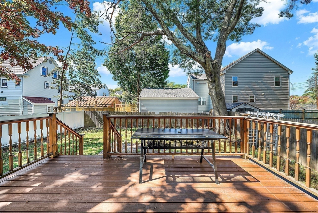 13 Weir Street Newton, MA 02466 - Photo 39 of 41 a view of a roof deck with table and chairs with wooden floor and fence