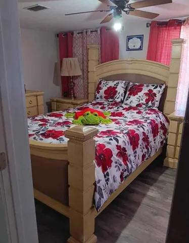 a bedroom with bed and a chandelier