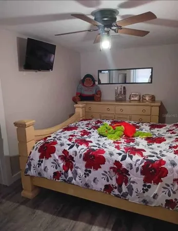 a bedroom with a bed and a flat screen tv