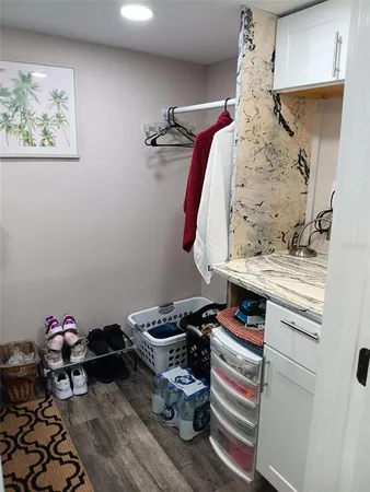a bathroom with a sink a toilet a window and shower