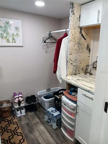 a bathroom with a sink a toilet a window and shower