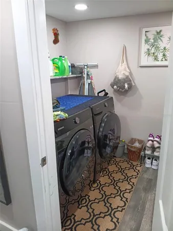 a kitchen with white cabinets and black appliances