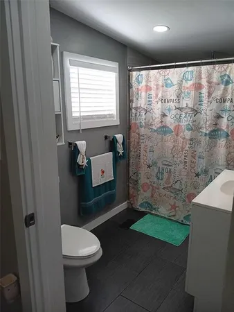 a bathroom with a toilet a sink and bathtub