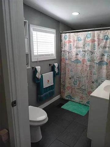 a bathroom with a toilet a sink and bathtub