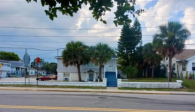 a front view of a house with a garden and plants