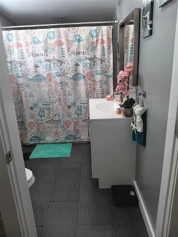 a bathroom with a sink vanity and a mirror
