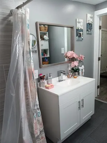 a kitchen with cabinets appliances and wooden floor
