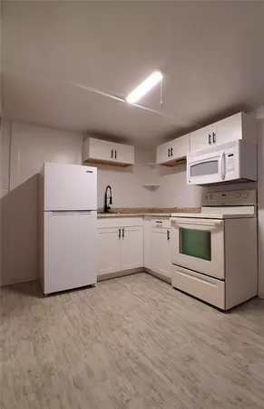 a room view with wooden floor and white walls