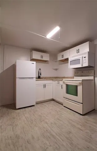 a room view with wooden floor and white walls