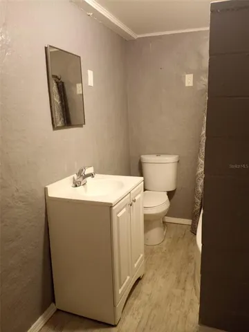 a view of a room with wooden floor and a ceiling fan
