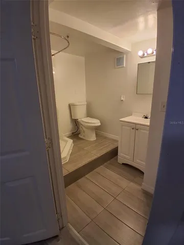 a bathroom with a glass shower door and a sink