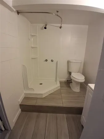 a bathroom with a toilet and a shower