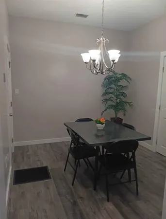 a view of a dining room with a table and chairs