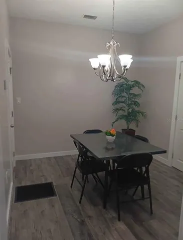 a view of a dining room with a table and chairs