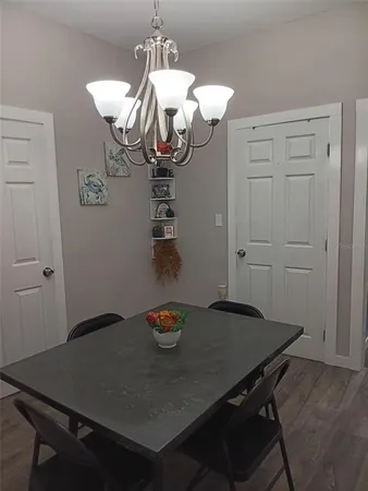 a view of a dining table chair and chandelier