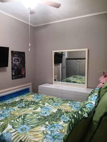 a bedroom with a bed and a television
