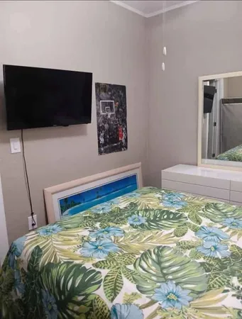 a bedroom with a bed and a flat screen tv