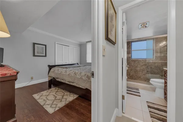 a bedroom with a bed and a mirror