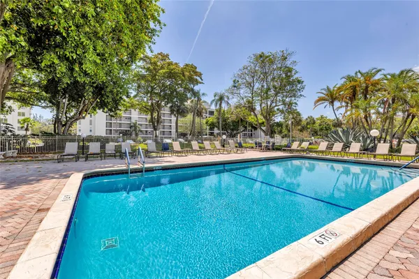 a view of swimming pool with outdoor seating and yard