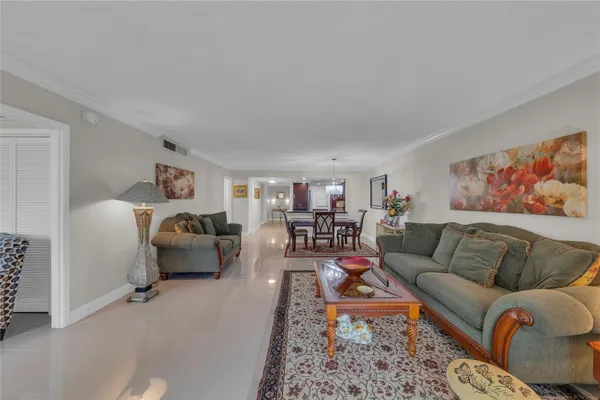 a living room with furniture a rug and a window
