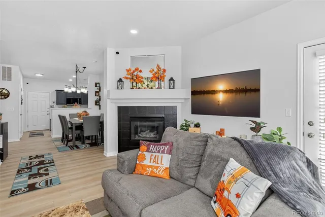a living room with furniture a flat screen tv and a fireplace