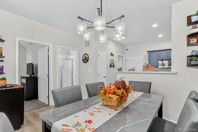 a living room with furniture and kitchen view