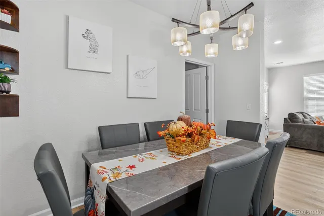 a view of a dining room with furniture and chandelier