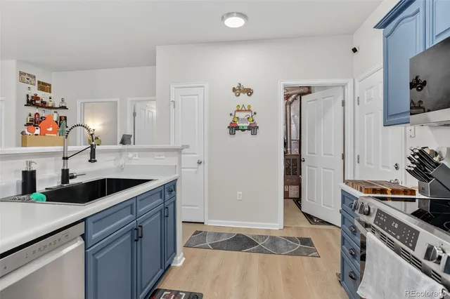 a kitchen with granite countertop a sink stove and cabinets
