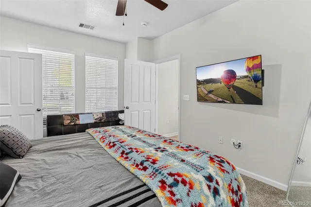 a bedroom with a bed and a painting on the wall