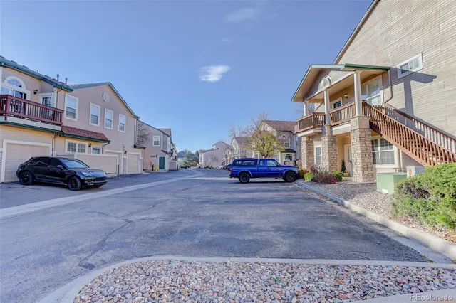 a view of a car park in front of a house