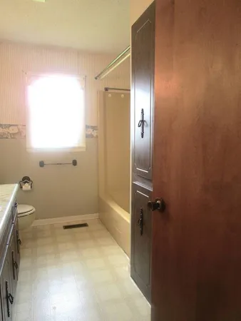 a bathroom with a granite countertop shower