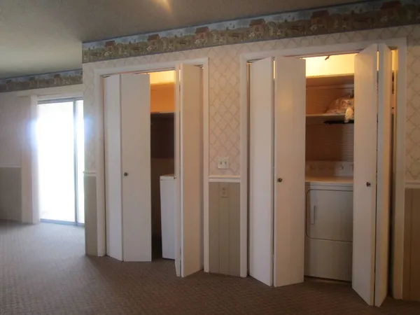 a view of a hallway with wooden shelves