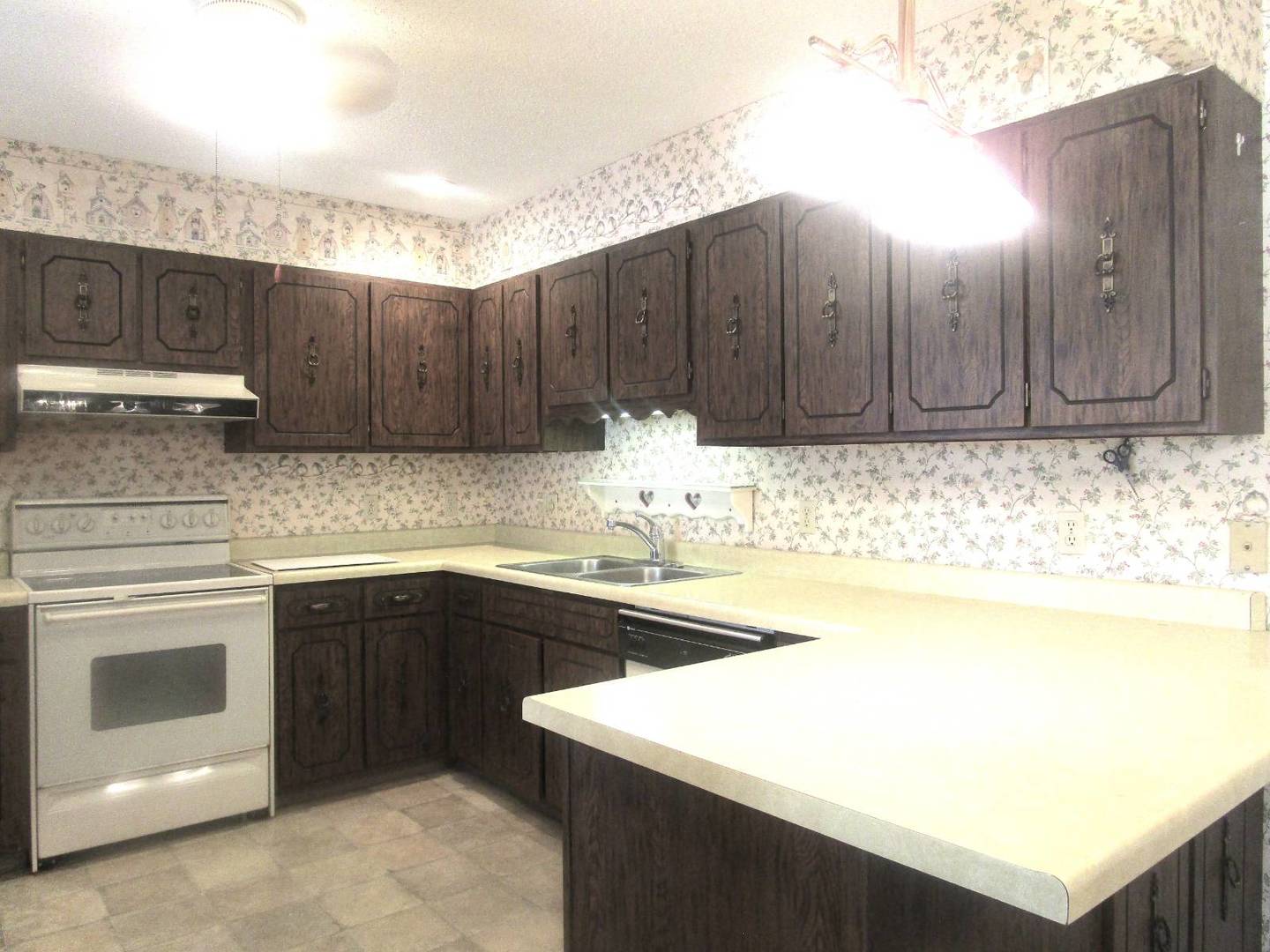 306 College Boulevard Carmi, IL 62821 - Photo 5 of 23 a kitchen with a sink and cabinets