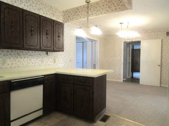a kitchen with wooden cabinets and sink