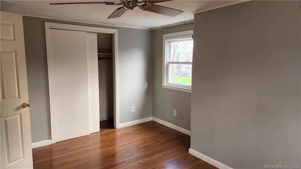 25 Madsen Road West Hartford, CT 06110 - Photo 13 of 16 a view of an empty room with a window and wooden floor