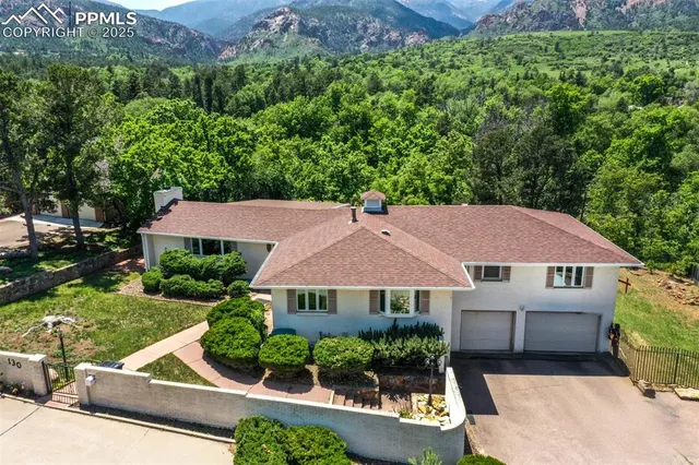 an aerial view of house with yard and outdoor seating