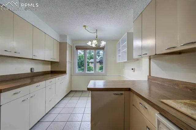 a kitchen with granite countertop white cabinets and a sink