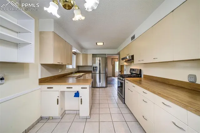 a kitchen with a sink cabinets and appliances