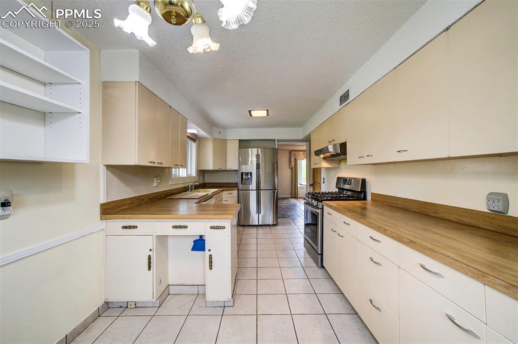 130 Cresta Road Colorado Springs, CO 80906 - Photo 14 of 49 a kitchen with a sink cabinets and appliances