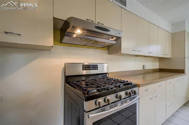 a white stove top oven sitting inside of a kitchen