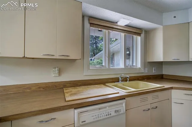 a kitchen with a sink and cabinets