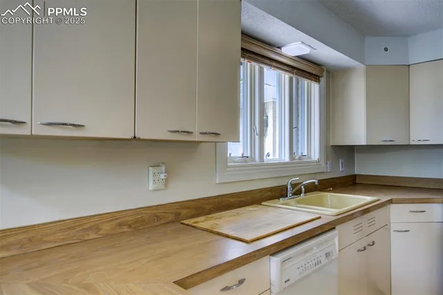 a kitchen with a sink and cabinets
