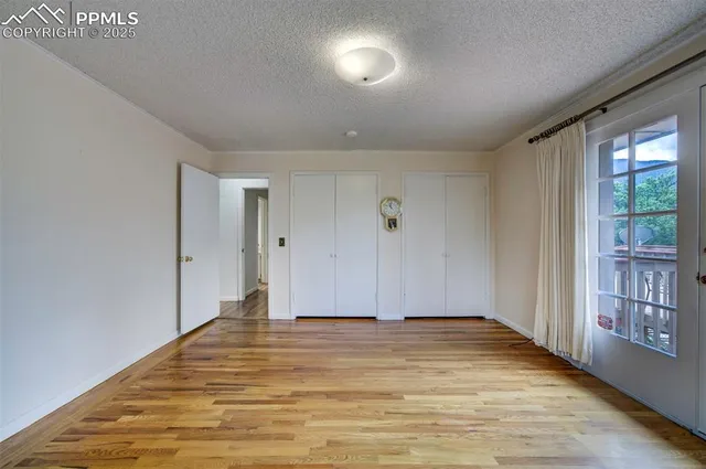 a view of room with window and wooden floor