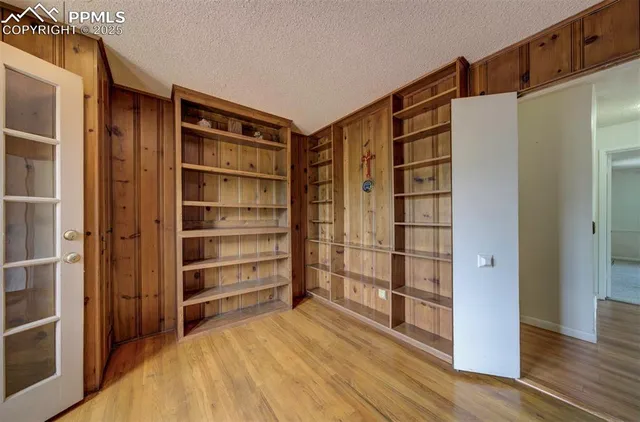 a room with walk in closet and wooden floor