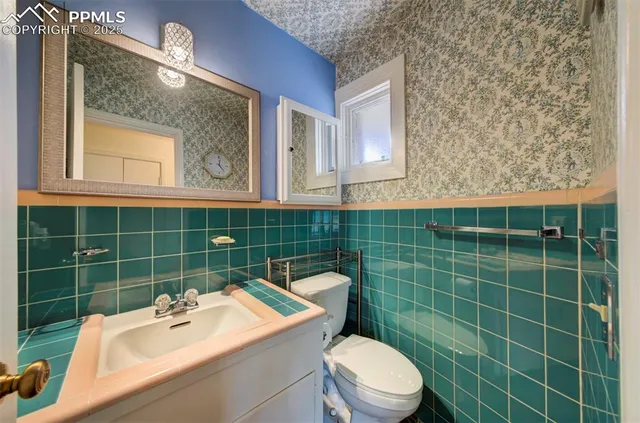 a bathroom with a sink mirror toilet and shower